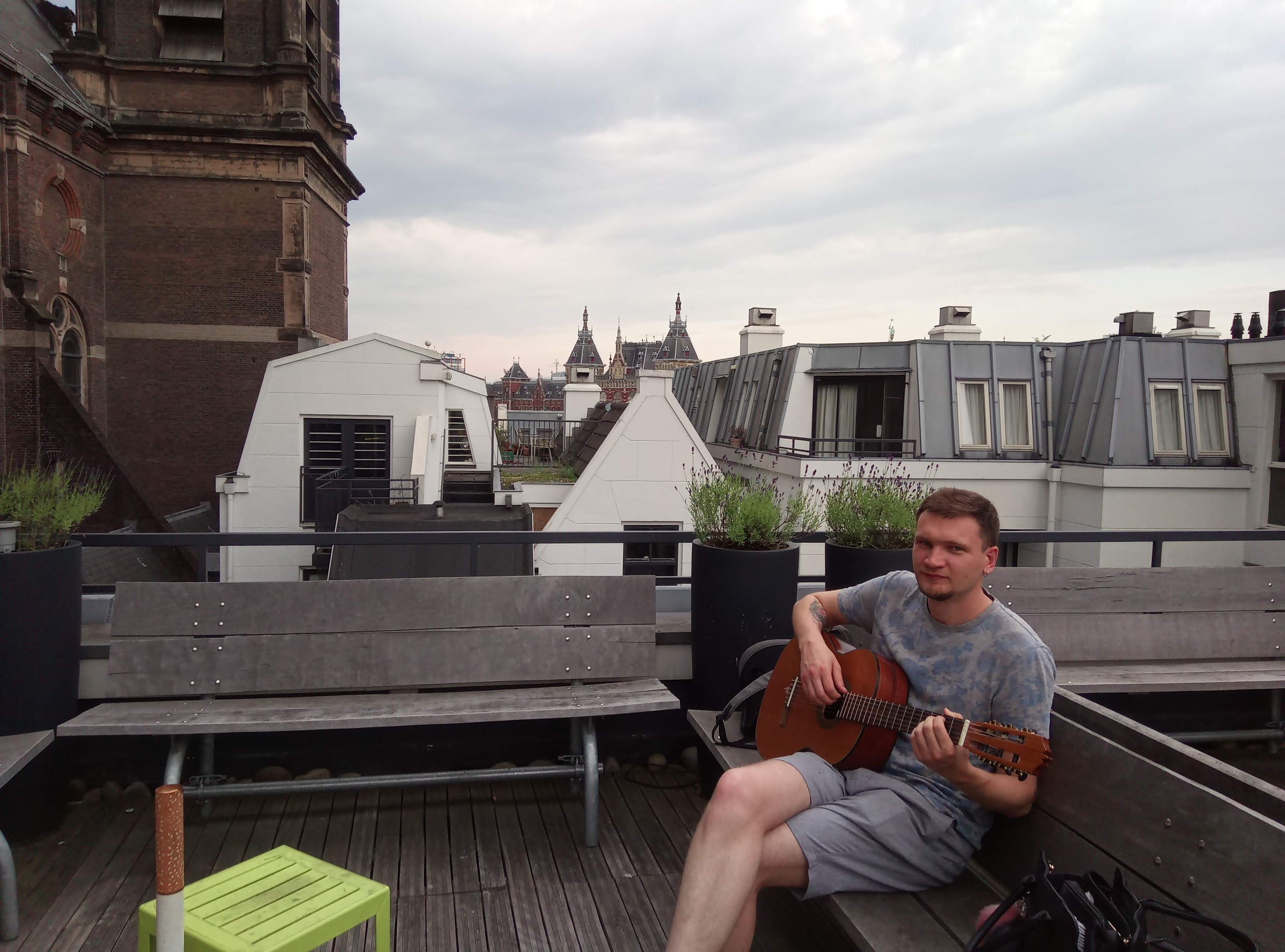 Sergey playing guitar with friends in Amsterdam